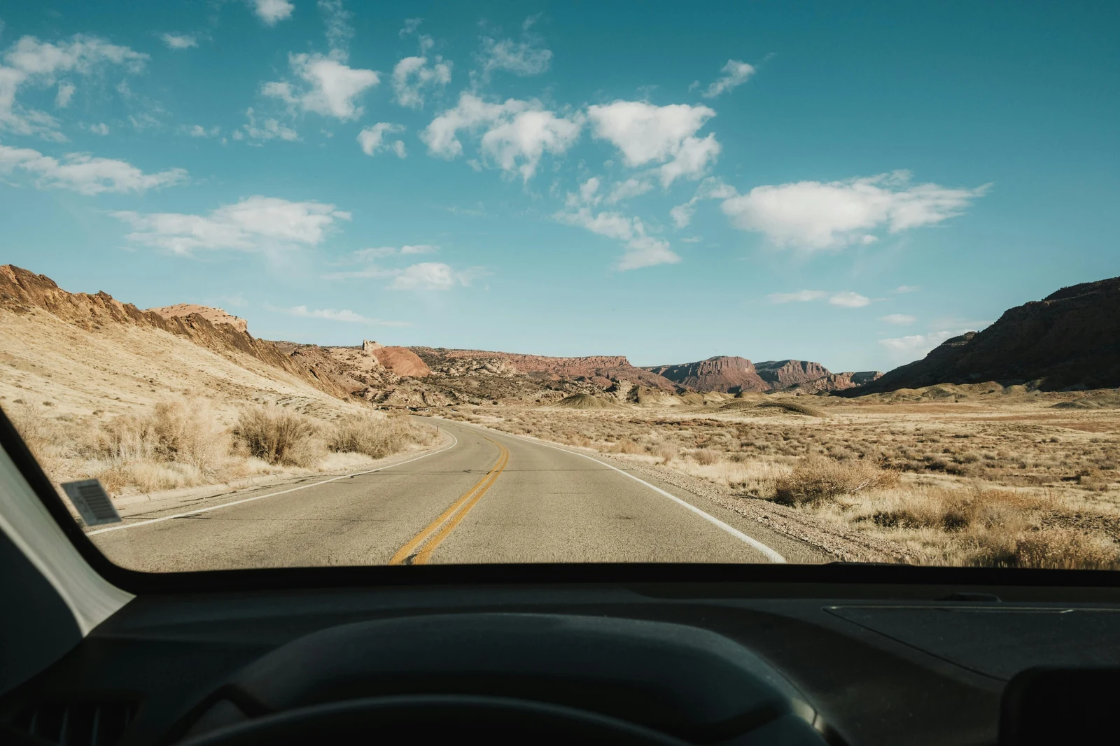 Mountain roadway through an open desert landscape